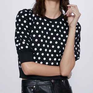 Black and white polka dot knit top.